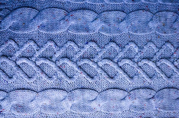 Bela textura de um suéter natural quente macio com um padrão tricotado de fios. O fundo
 - Foto, Imagem