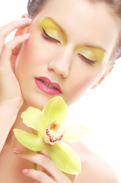 young woman with bright make up holding orchid - Fotografie, Obrázek