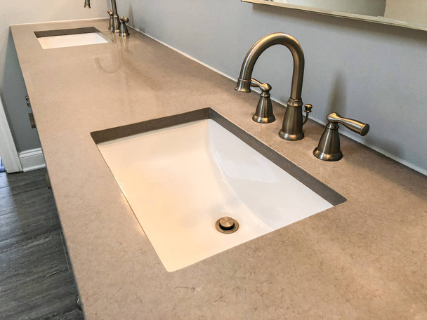 Bathroom vanity quartz countertop with white rectangular sinks and chrome faucets - Photo, Image
