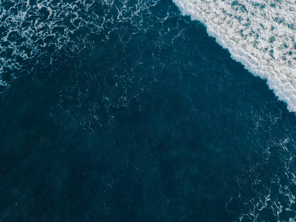 Aerial view beautiful of sea waves from drone. Stock image of blue color of ocean water, sea surface. Top view on turquoise waves, clear water surface texture.  Top view, amazing nature background - Photo, Image