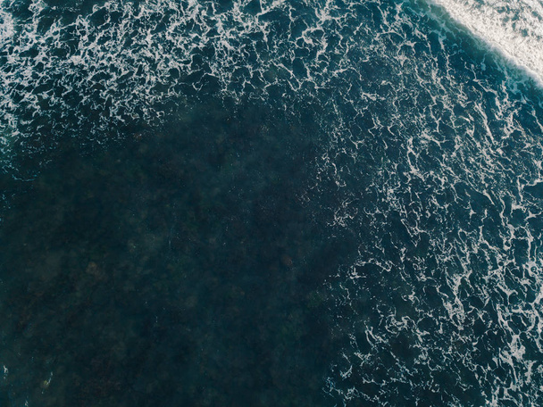 Aerial view beautiful of sea waves from drone. Stock image of blue color of ocean water, sea surface. Top view on turquoise waves, clear water surface texture.  Top view, amazing nature background - Foto, afbeelding