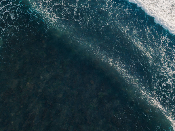 Aerial view beautiful of sea waves from drone. Stock image of blue color of ocean water, sea surface. Top view on turquoise waves, clear water surface texture.  Top view, amazing nature background - Zdjęcie, obraz