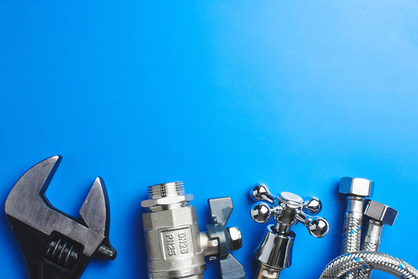 plumbing tools and equipment on blue background with copy space - Fotó, kép