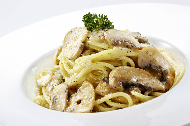 Delicious pasta on white background. Fresh pasta with mushrooms and spices closeup - Photo, Image
