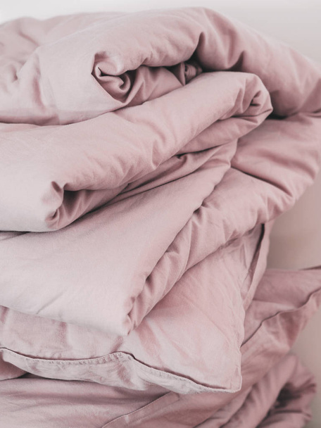 Close view of bed linen pillows and blankets in pink pastel colors - Foto, Imagen