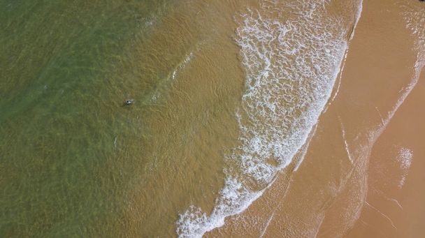 Aerial view beautiful of sea waves, sand from drone. Stock image ocean water, sea surface, sand. Top view on turquoise waves, clear water surface texture. Top view, amazing nature beach background - Φωτογραφία, εικόνα