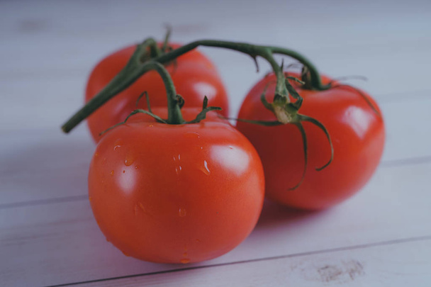 Red, juicy tomatoes on wooden background, concept: fresh vegetables, healthy food. - Foto, Imagem