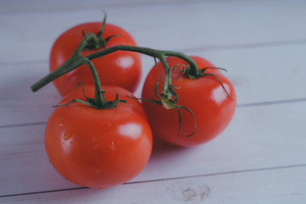 Red, juicy tomatoes on wooden background, concept: fresh vegetables, healthy food. - Φωτογραφία, εικόνα