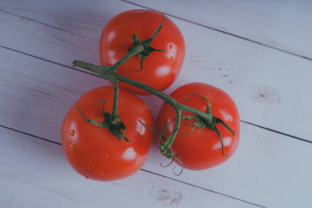 Red, juicy tomatoes on wooden background, concept: fresh vegetables, healthy food. - Фото, зображення