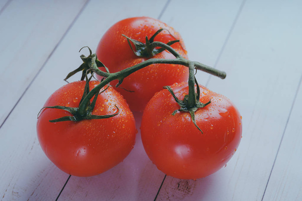 Red, juicy tomatoes on wooden background, concept: fresh vegetables, healthy food. - 写真・画像