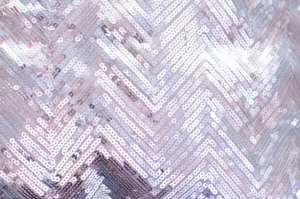 Texture tissu avec paillettes argentées chatoyantes. Arrière-plan avec sequins
. - Photo, image