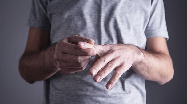 Caucasian man with finger ache. Arthritis, wrist pain - Zdjęcie, obraz