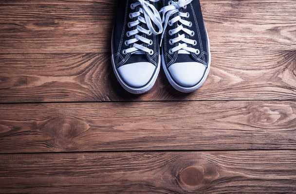 Sneakers on a wooden background. - Photo, Image