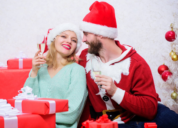 Happy new year and merry christmas. Celebrating christmas together. Couple in love enjoy christmas holiday celebration. Family tradition. Loving couple cuddle and drink champagne near christmas tree - Φωτογραφία, εικόνα