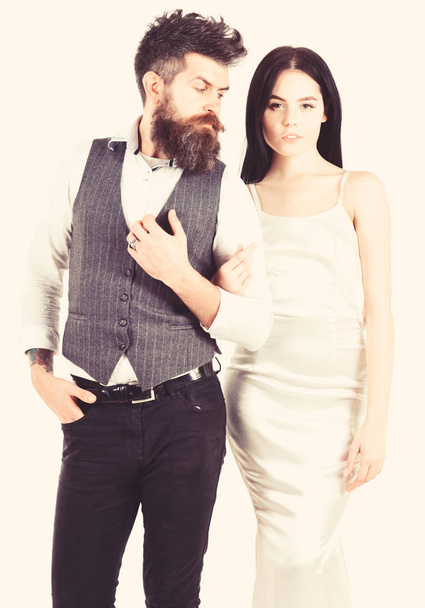 Woman in wedding dress and man in vest. Wedding concept. Couple in love, bride and groom in elegant wedding clothes, white background. Bearded hipster with bride dressed up for wedding ceremony - Φωτογραφία, εικόνα