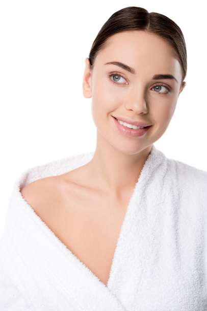 beautiful smiling woman in bathrobe looking away isolated on white - Фото, зображення