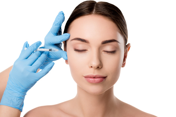 doctor in latex gloves giving beauty injection with syringe to woman with eyes closed isolated on white - Foto, Imagem