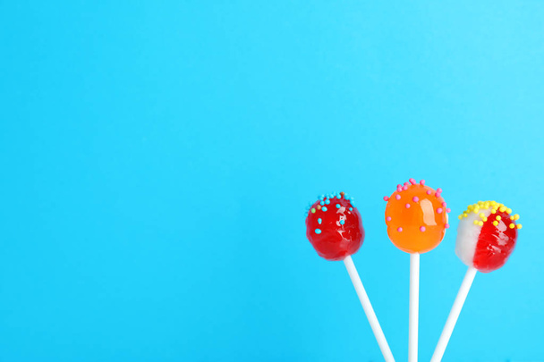 Bright yummy candies on color background. Space for text - 写真・画像