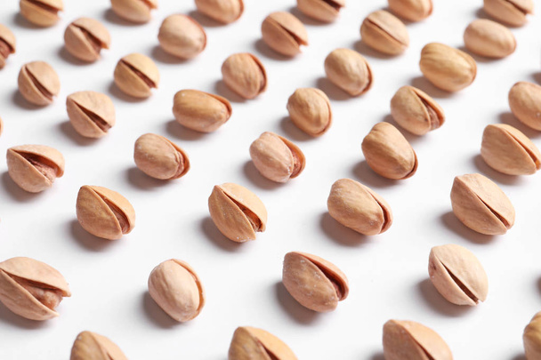 Organic pistachio nuts in shell on white background - 写真・画像