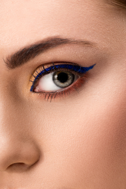close up of female eye with blue eyeliner and perfect skin - 写真・画像
