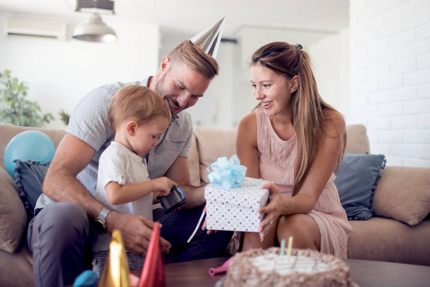Caucasian  boy  with family celebrating birthday party,open the gift. - Photo, Image