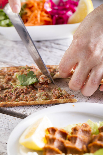 частковий вид шеф-кухаря, що ріже запечену піцу з ножем
 - Фото, зображення