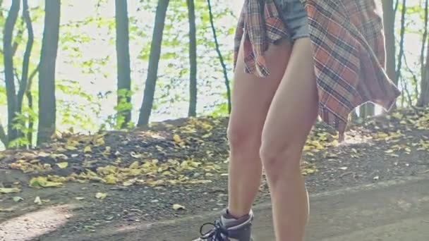 Happy young woman on roller skates in the summer park - Filmmaterial, Video