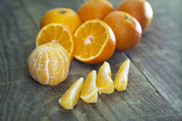 A lot of tangerines on a wooden background. - Photo, Image