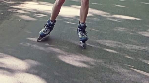 Feet of a woman roller skating on tarmac - Кадри, відео