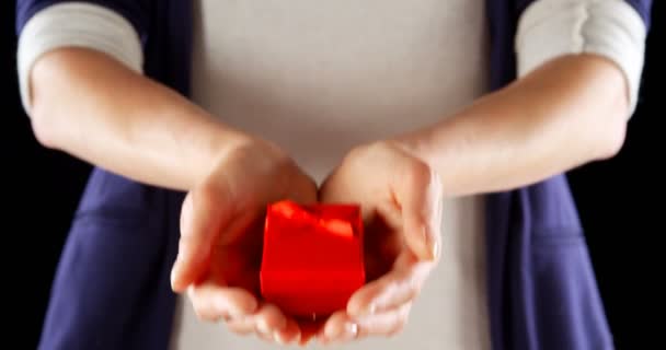 Close-up of hands holding small red gift box. Mid section of man holding in cupped hands 4k - Imágenes, Vídeo