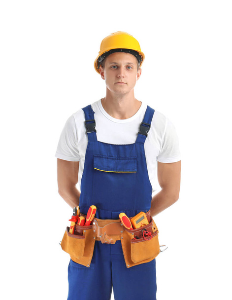 Electrician with tools wearing uniform on white background - Zdjęcie, obraz
