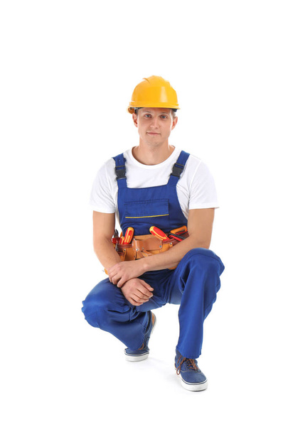 Electrician with tools wearing uniform on white background - Photo, image