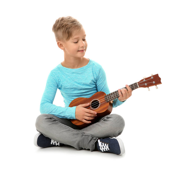 Little boy playing guitar isolated on white - Photo, image