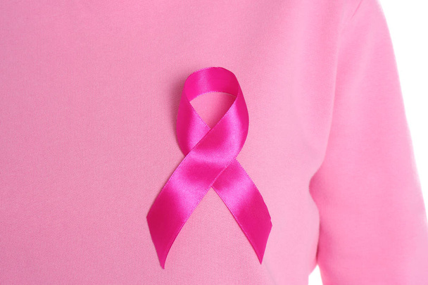 Woman with pink ribbon on white background, closeup. Breast cancer awareness - Photo, Image
