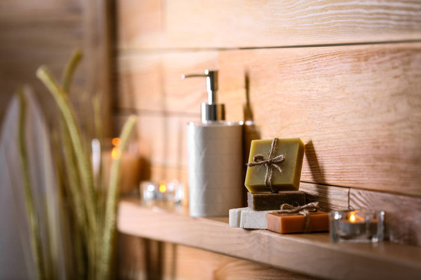 Soap bars and toiletries on wooden shelf. Space for text - Фото, зображення