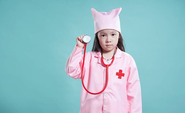 Little cute asian girl wear medical suit ,kid dream become nurse or doctor concept . - Photo, image