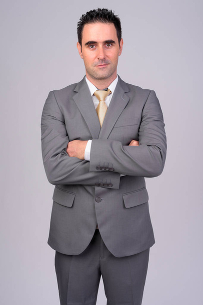 Handsome businessman wearing suit against white background - Zdjęcie, obraz