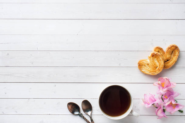 Valentine's day Breakfast concept. Cup of coffee and a cookies hearts on a white table. copy space, flat lay - Fotoğraf, Görsel