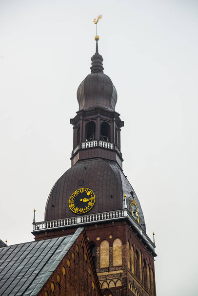 The Golden Cockerel on the clock tower. Riga Cathedral on Dome Square at the historical center in the old town of Riga, Latvia. Winter landscape - Photo, Image