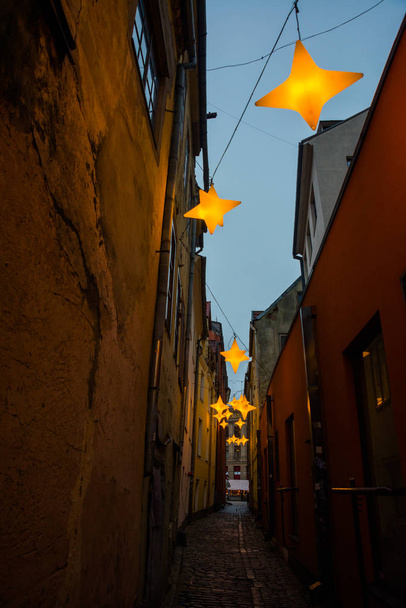 Вузькі вулиці Rozena в Старе місто Риги, Латвії з зірочок Гарленд. Новорічне прикраса на європейських вулиці. Rozena iela - Фото, зображення