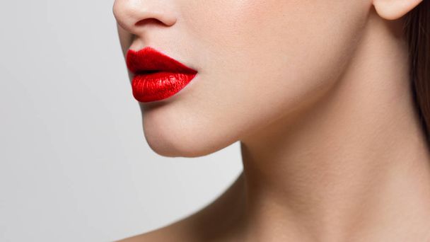 Sexual full lips. Natural gloss of lips and woman's skin. The mouth is closed. Increase in lips, cosmetology. Orange lips and long neck. Great summer mood with open eyes. - Photo, image