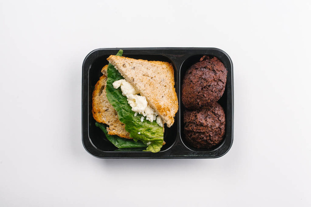Κάτοψη της σωστής διατροφής, σάντουιτς και κέικ σε πλαίσιο σε λευκό φόντο - Φωτογραφία, εικόνα