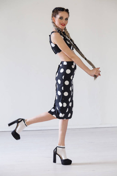 beautiful fashionable woman in a dress with white circles portrait - 写真・画像