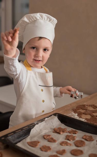 Baby Makes Christmas Cookies. Culinary Concept. Christmas Cooking. Children - 写真・画像