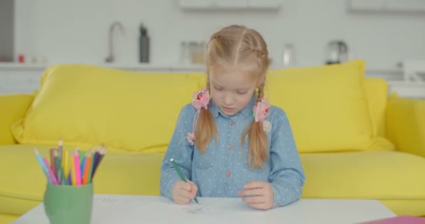 Creative little girl engrossed in drawing at home - Felvétel, videó