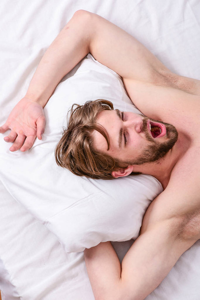 Man handsome guy lay in bed. Get adequate and consistent amount of sleep every night. Expert tips on sleeping better. How much sleep you actually need. Bearded man sleeping face relaxing on pillow - Photo, Image