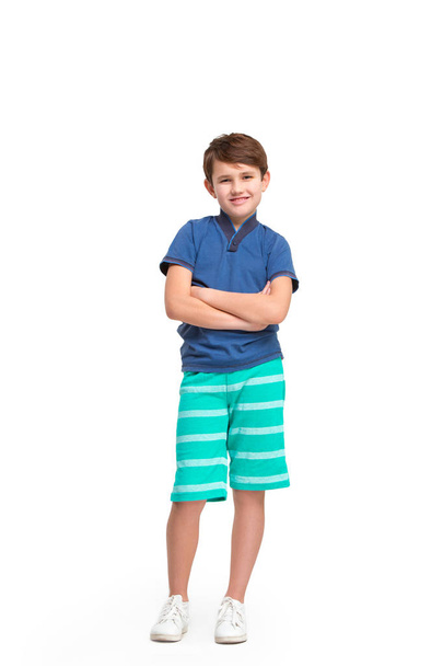 Full length portrait of cute little kid in stylish clothes looking at camera and smiling - Foto, afbeelding