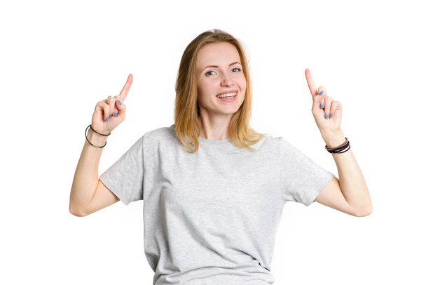 Portrait of young happy woman pointing finger up, isolated on white background. - Zdjęcie, obraz