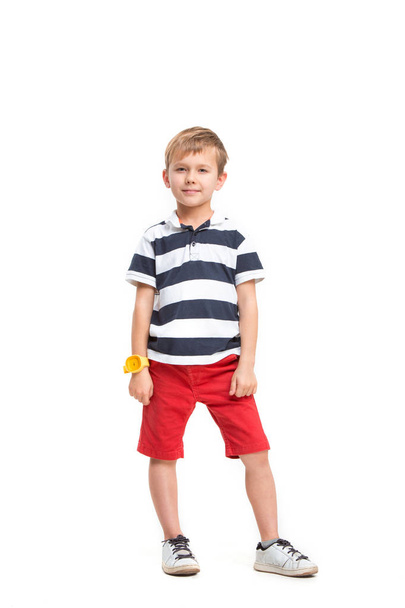 Full length portrait of cute little kid in stylish clothes looking at camera and smiling - Foto, Imagem