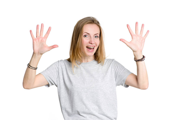 Portrait of a young happy woman showing ten fingers on two hands, isolated on white background. - Foto, immagini